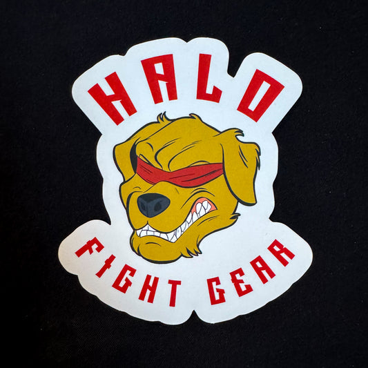 The image shows a Halo Fight Gear Insignia Sticker on a black background. The sticker features the Halo Fight Gear logo, a fierce golden retriever with bared teeth and wearing a red blindfold. "HALO" is written in bold red letters above the dog's head, while "FIGHT GEAR" appears below, also in bold red letters.
The image shows a Halo Fight Gear Insignia Sticker on a black background. The sticker features the Halo Fight Gear logo, a fierce golden retriever with bared teeth and wearing a red blindfold. "HALO"